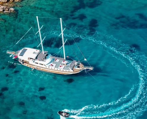 Traditional Turkish gulet anchored in a pine-fringed bay on the Fethiye to Gocek gulet cruise route in Turkey