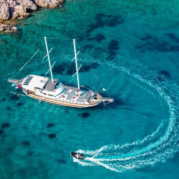 Traditional Turkish gulet anchored in a pine-fringed bay on the Fethiye to Gocek gulet cruise route in Turkey