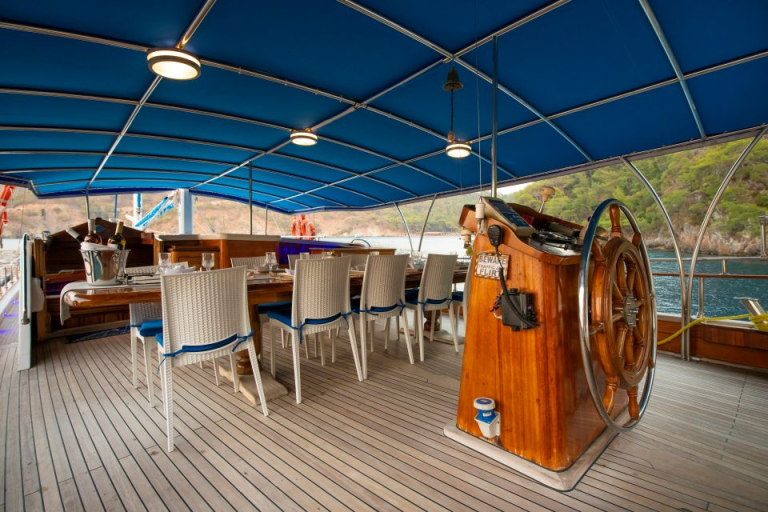 Northwind Gulet – Covered Aft Deck with Classic Wooden Helm and Dining Area