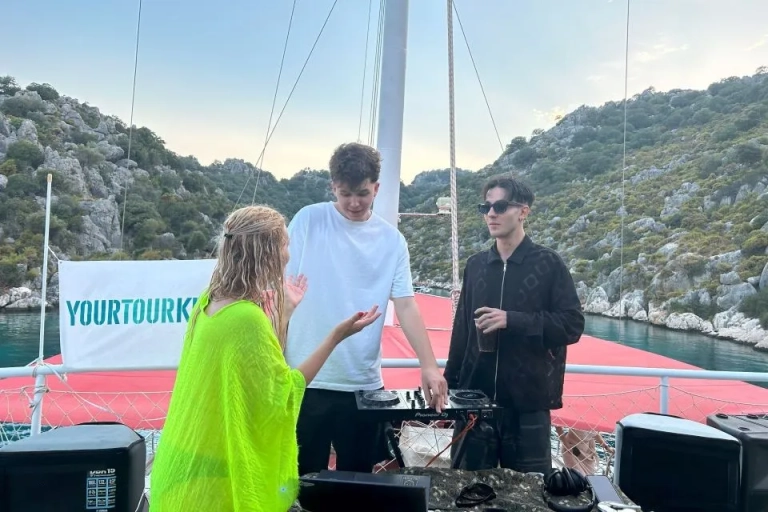DJ performing on M.O.S.C. Blue Cruise with stunning coastal views - YourTourKey experience in Turkey