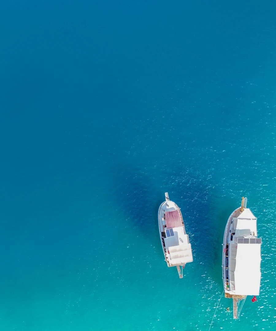 Aerial view of two gulets anchored in turquoise waters during a daily boat tour in Kekova, Turkey – offered by YourTourKey.