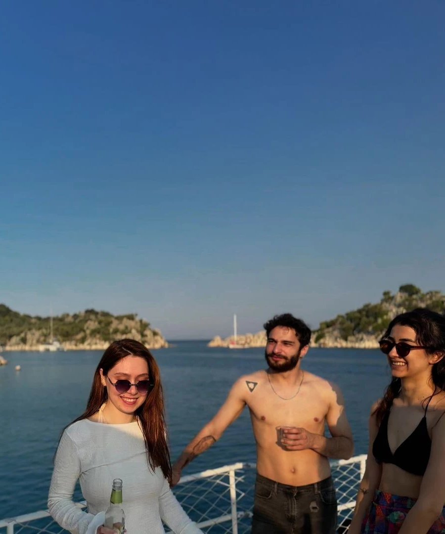Young adults enjoying a Blue Cruise on a Turkish gulet – mobile view of a summer sailing adventure in Turkey.