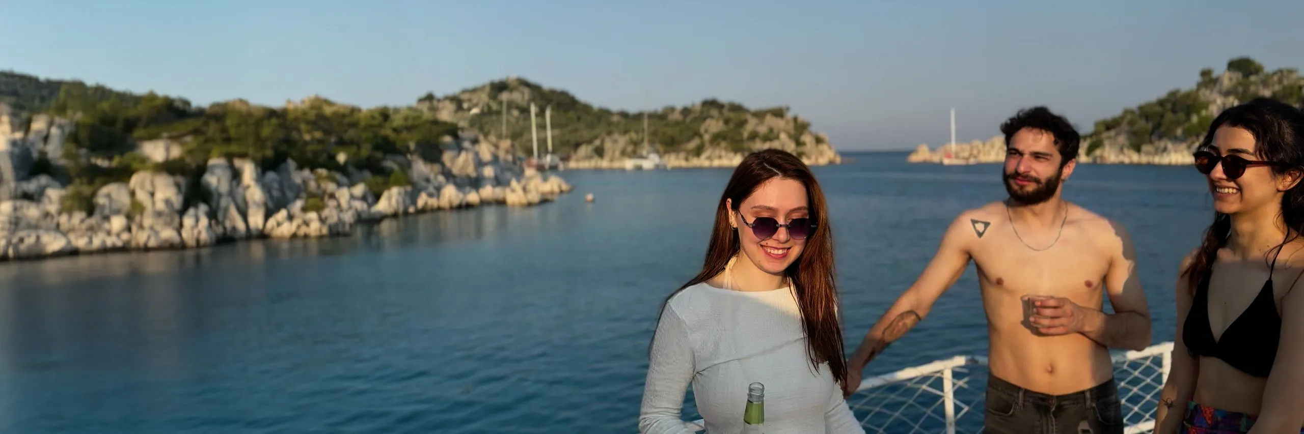 Young adults enjoying a gulet cruise on the Mediterranean – Blue Cruise experience in Turkey with scenic views and good vibes.